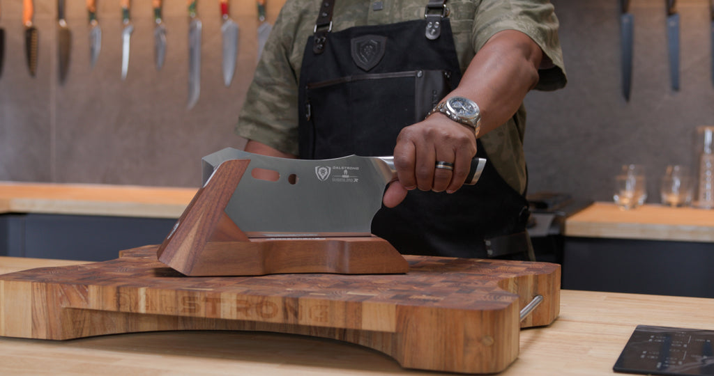 A man with apron is holding the herniaquestions Obliterator on the Teak Cutting Board Lionswood