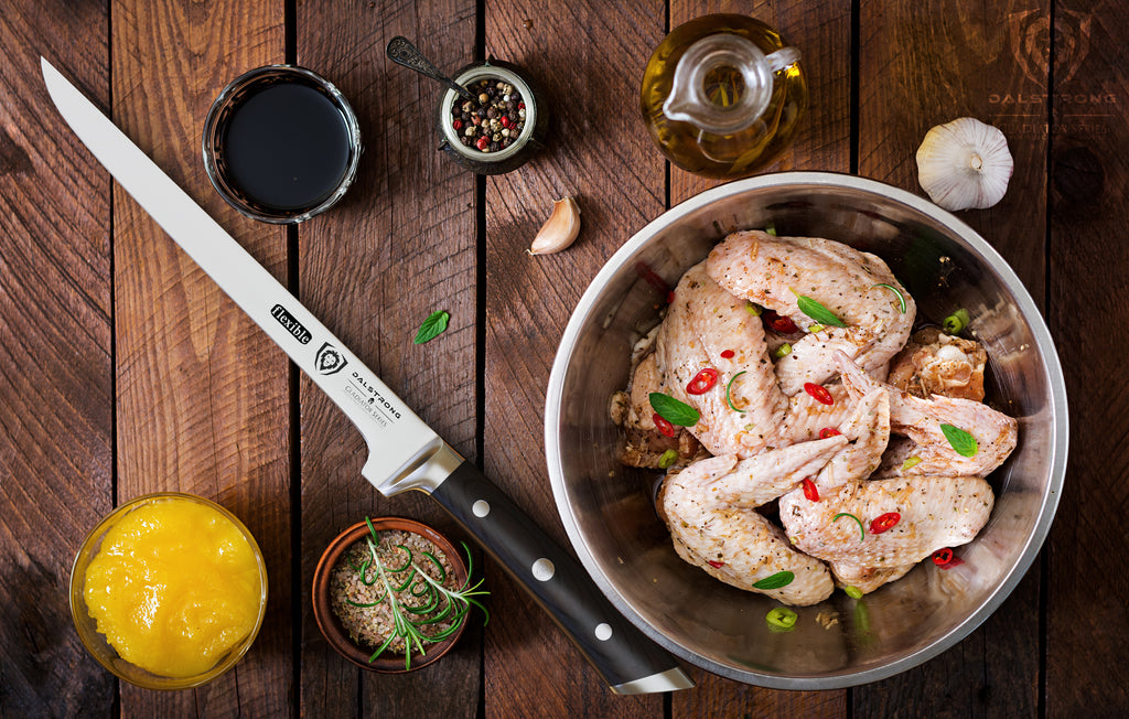 chicken wings ready to be smoked with boning knife