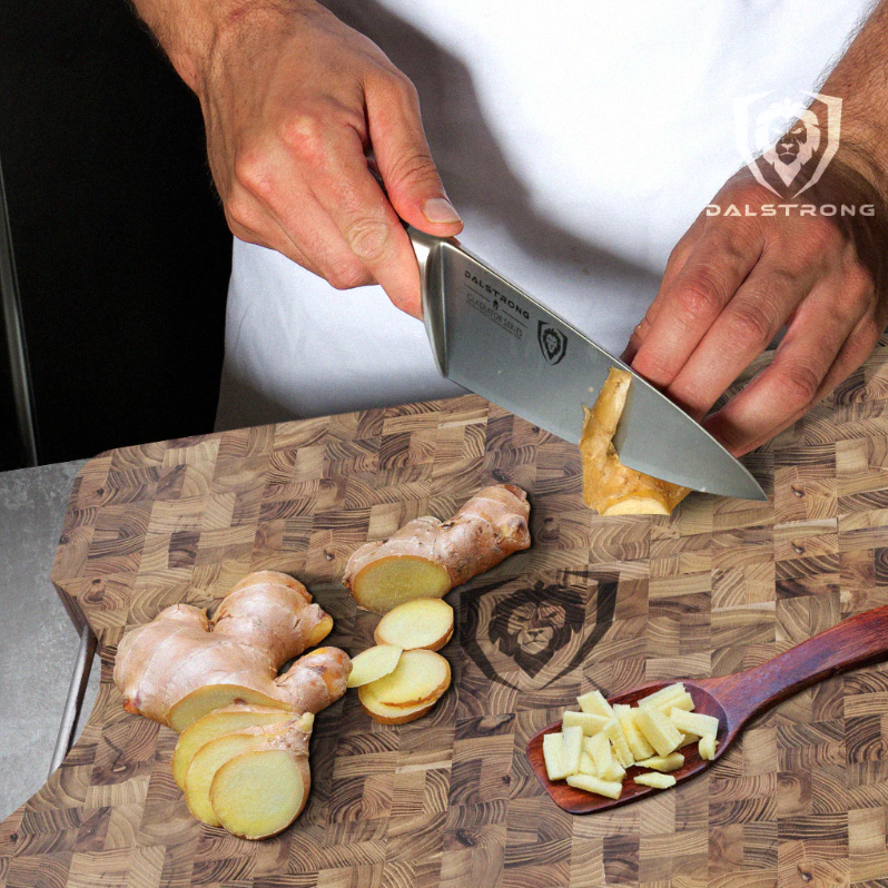 slicing ginger root with a chef's knife on a herniaquestions cutting board