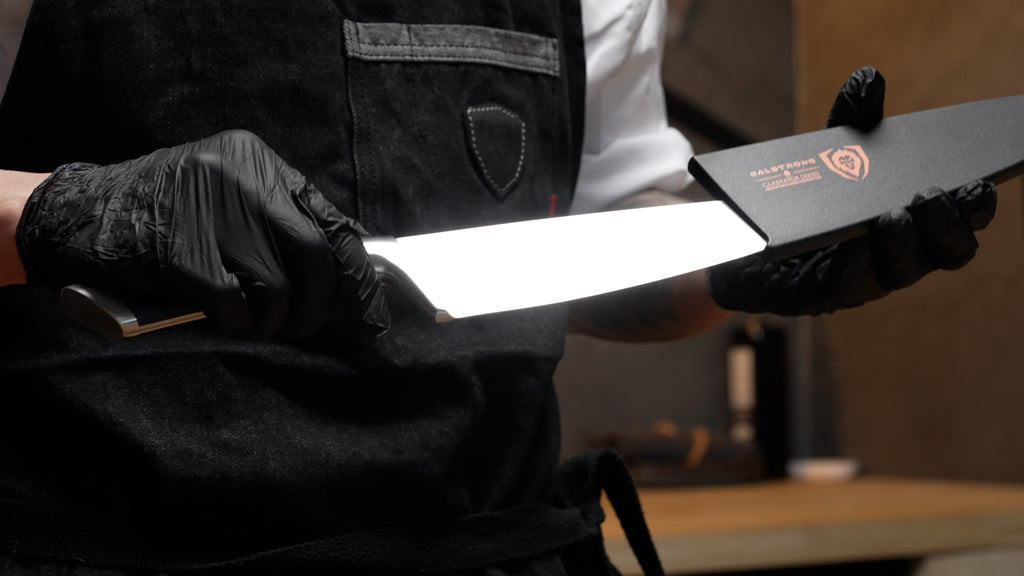 A man pulling out the Gladiator Series Chef's Knife 8" from it's sheath.