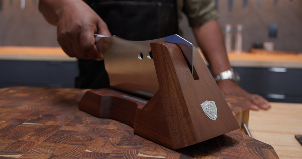 A man holding the Gladiator Series R Meat Cleaver 9" with Stand